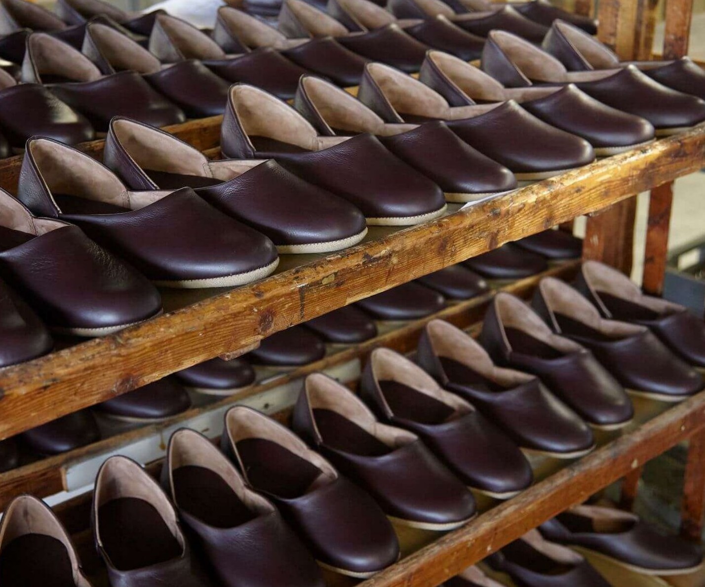 Rows of handcrafted Draper of Glastonbury sheepskin slippers.